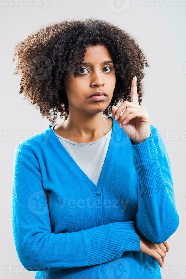 Portrait of pensive Afro woman with a blue cardigan photo