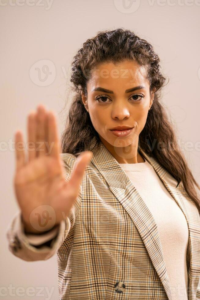 Portrait of a pensive businesswoman with stop sign photo