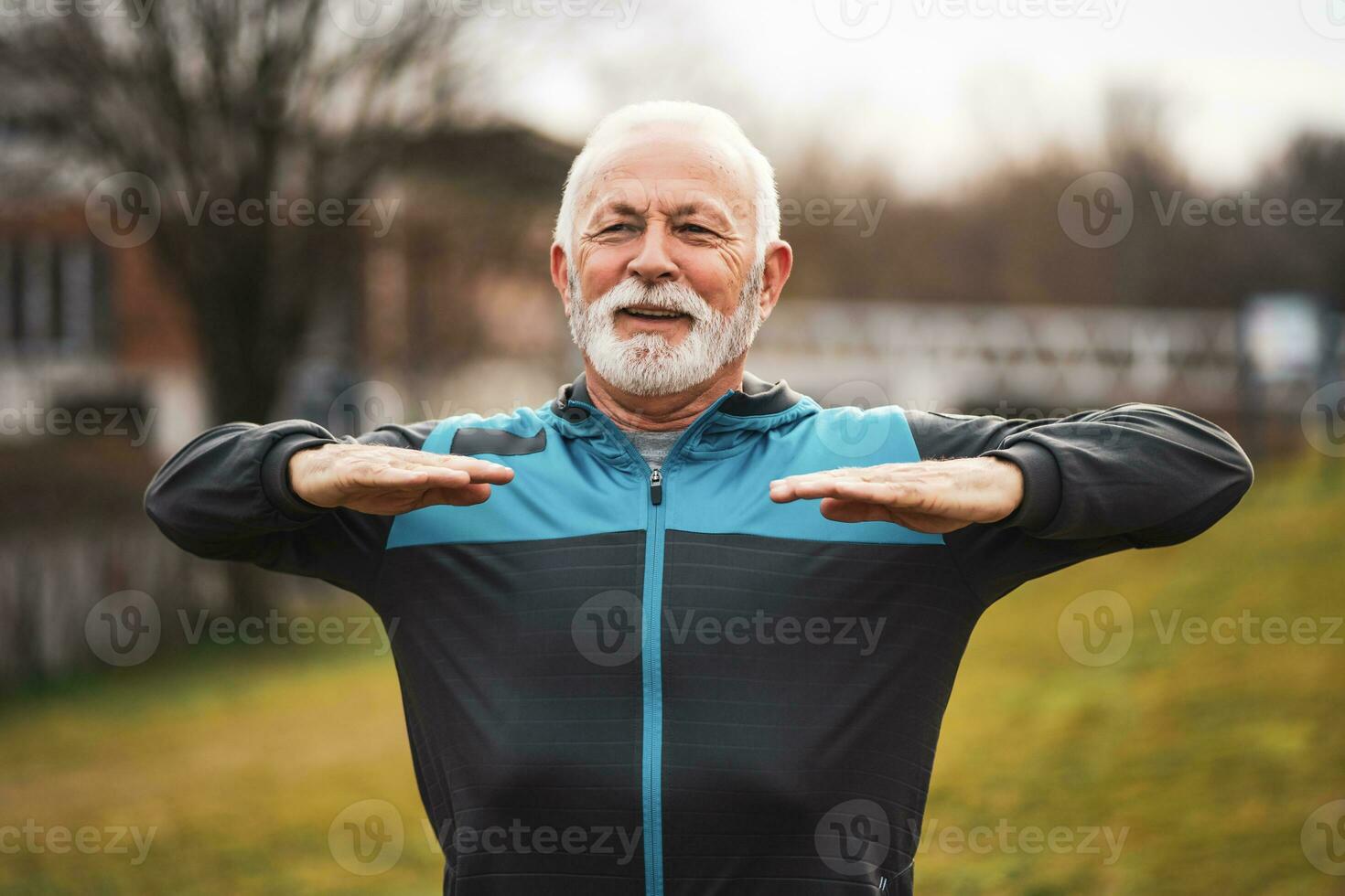A senior man doing physical exercises photo