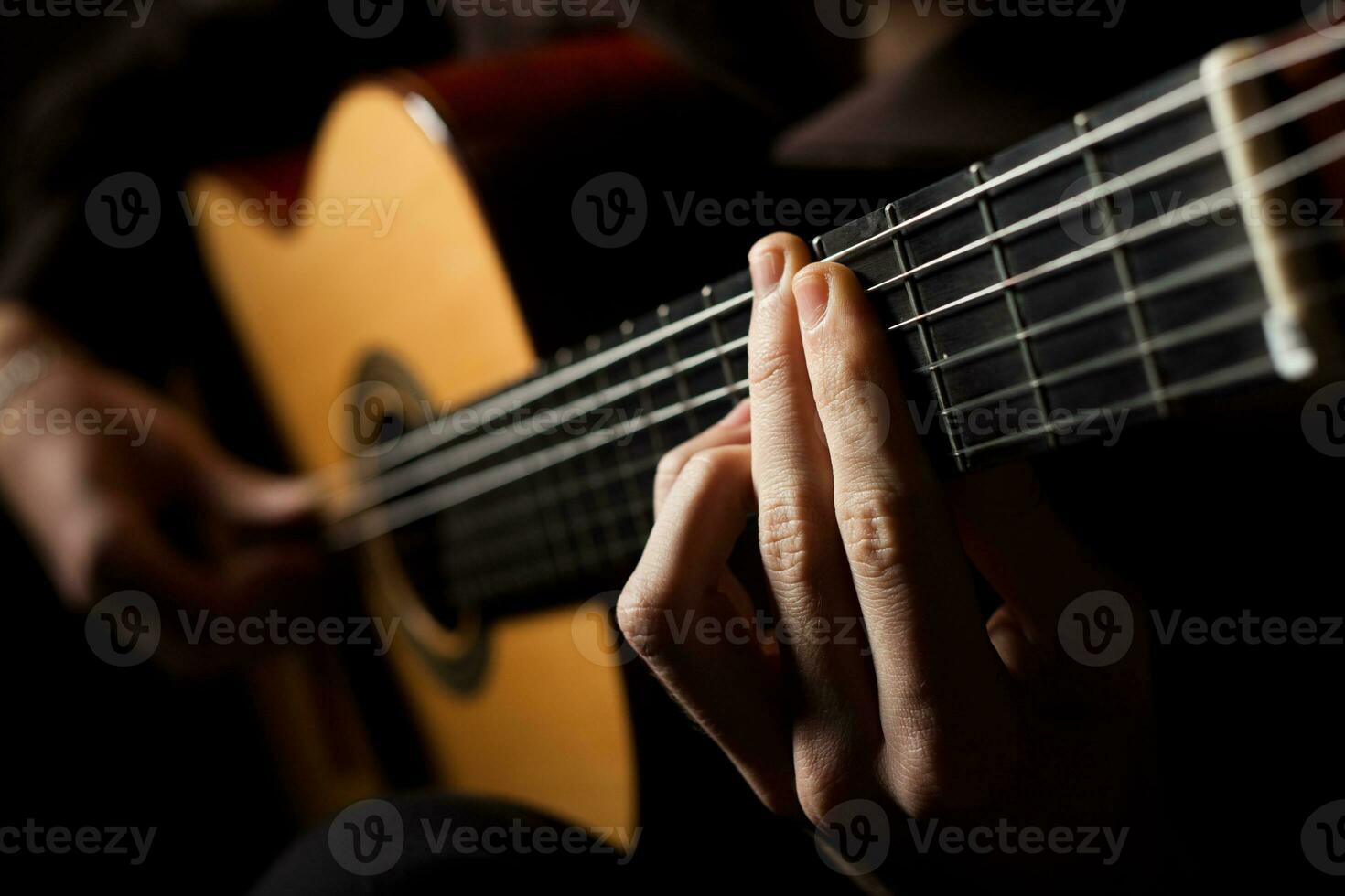 Playing an acoustic guitar photo
