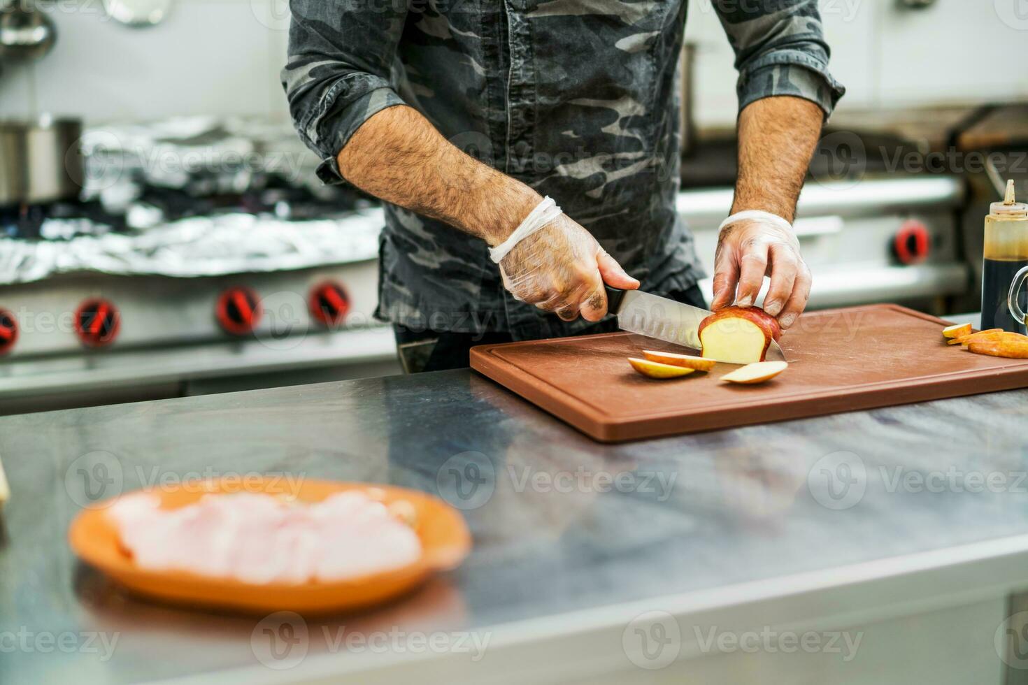 A chef is preparing a meal in the restaurant's kitchen. photo