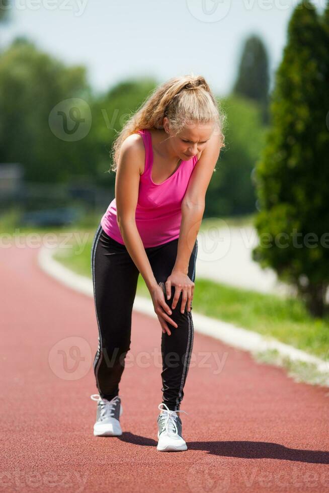 A woman doing physical exercises with knee pain photo