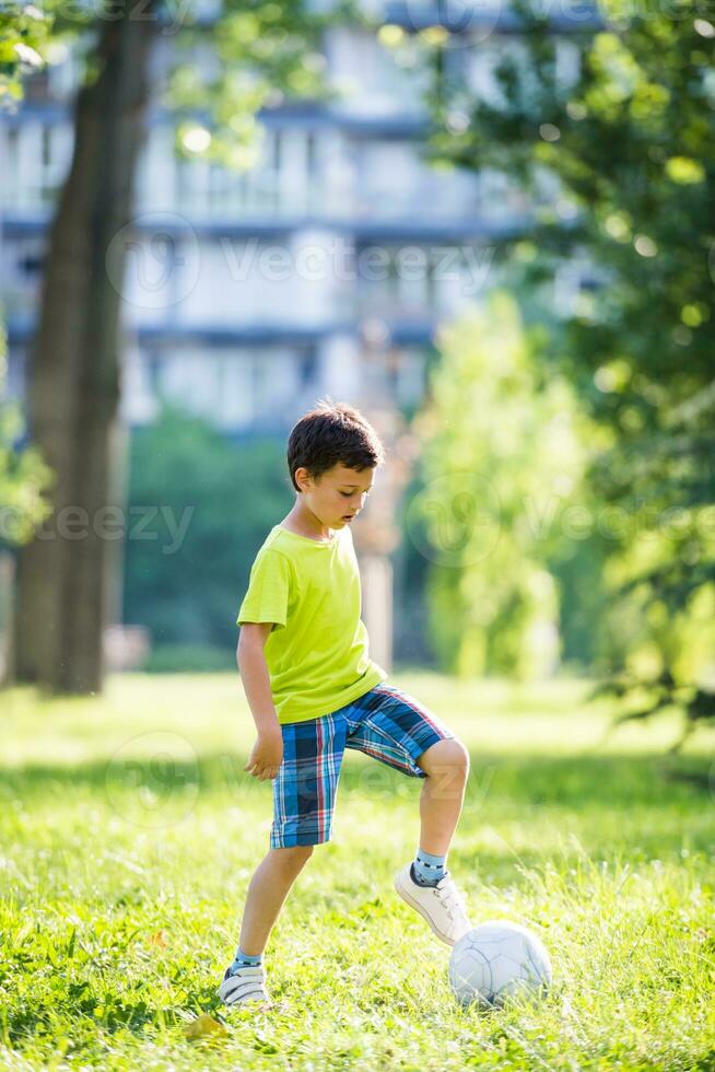 A boy playing with a ball photo