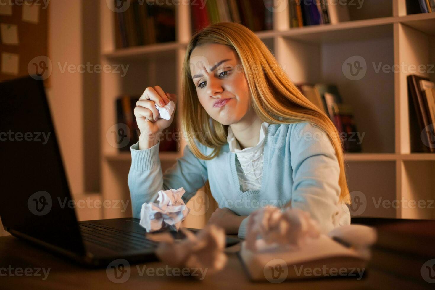 Tired college girl studying late night at home with the flu photo