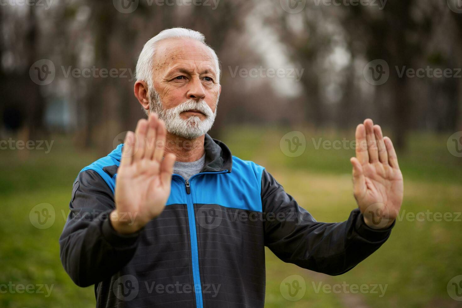 A senior man doing physical exercises photo