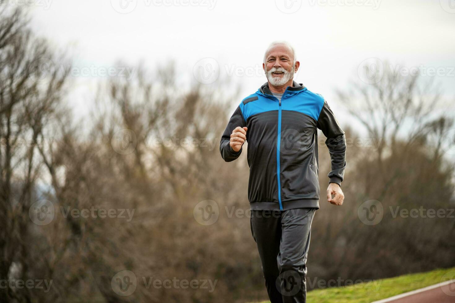 A senior man doing physical exercises photo