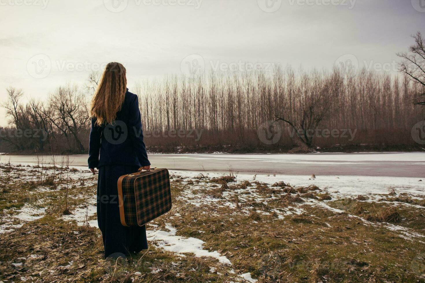 A woman with a travel bag photo