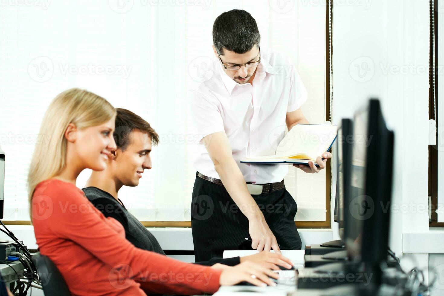 Students learning in a computer lab photo