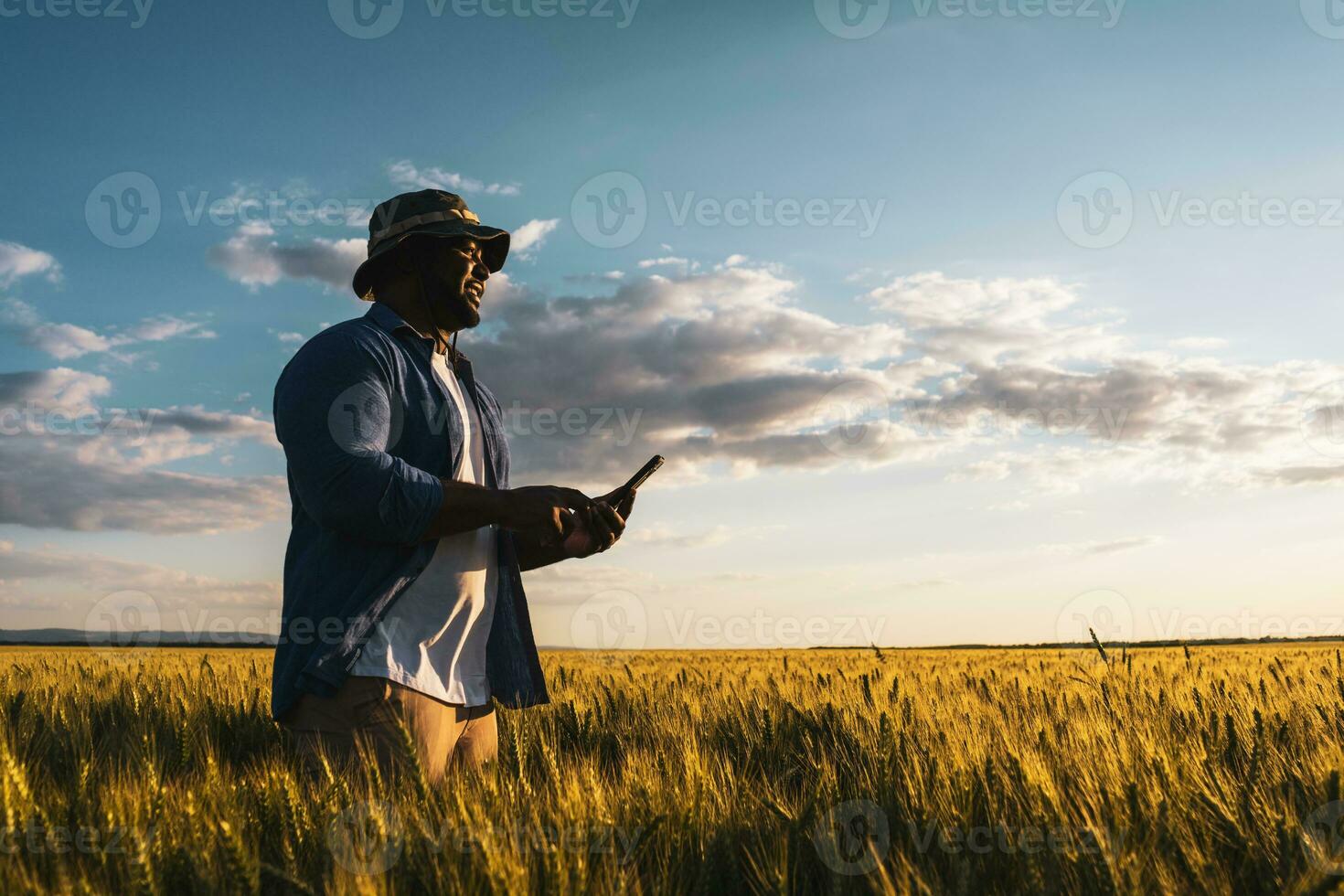 Afro farmer examining the crop photo