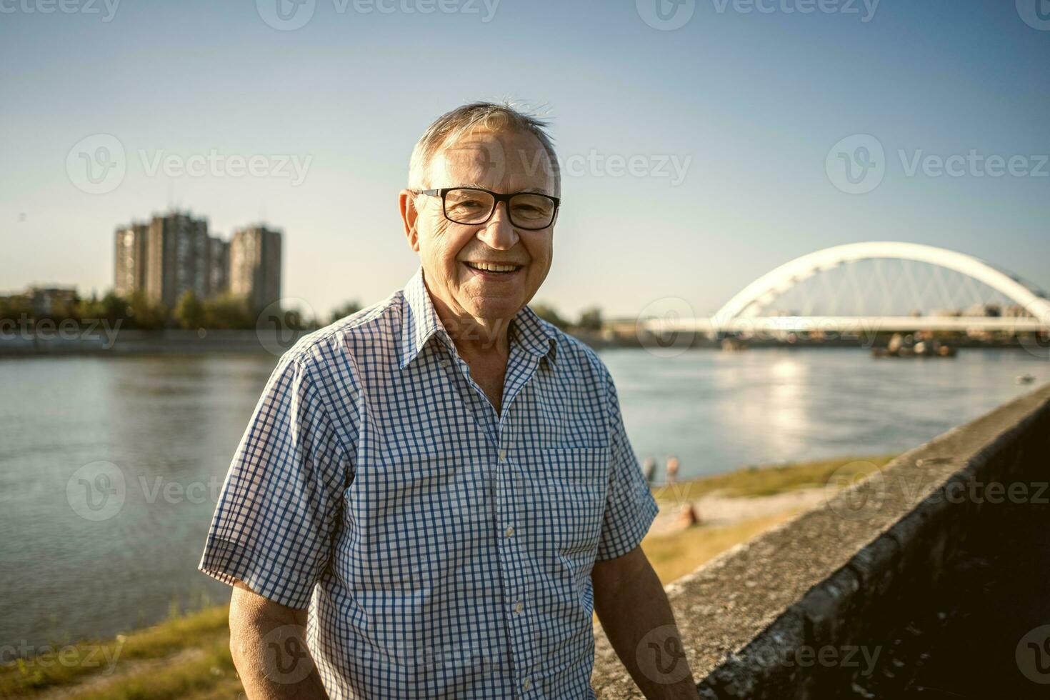 Happy senior man sitting outside photo