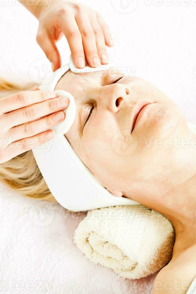 Mature woman having a face treatment photo