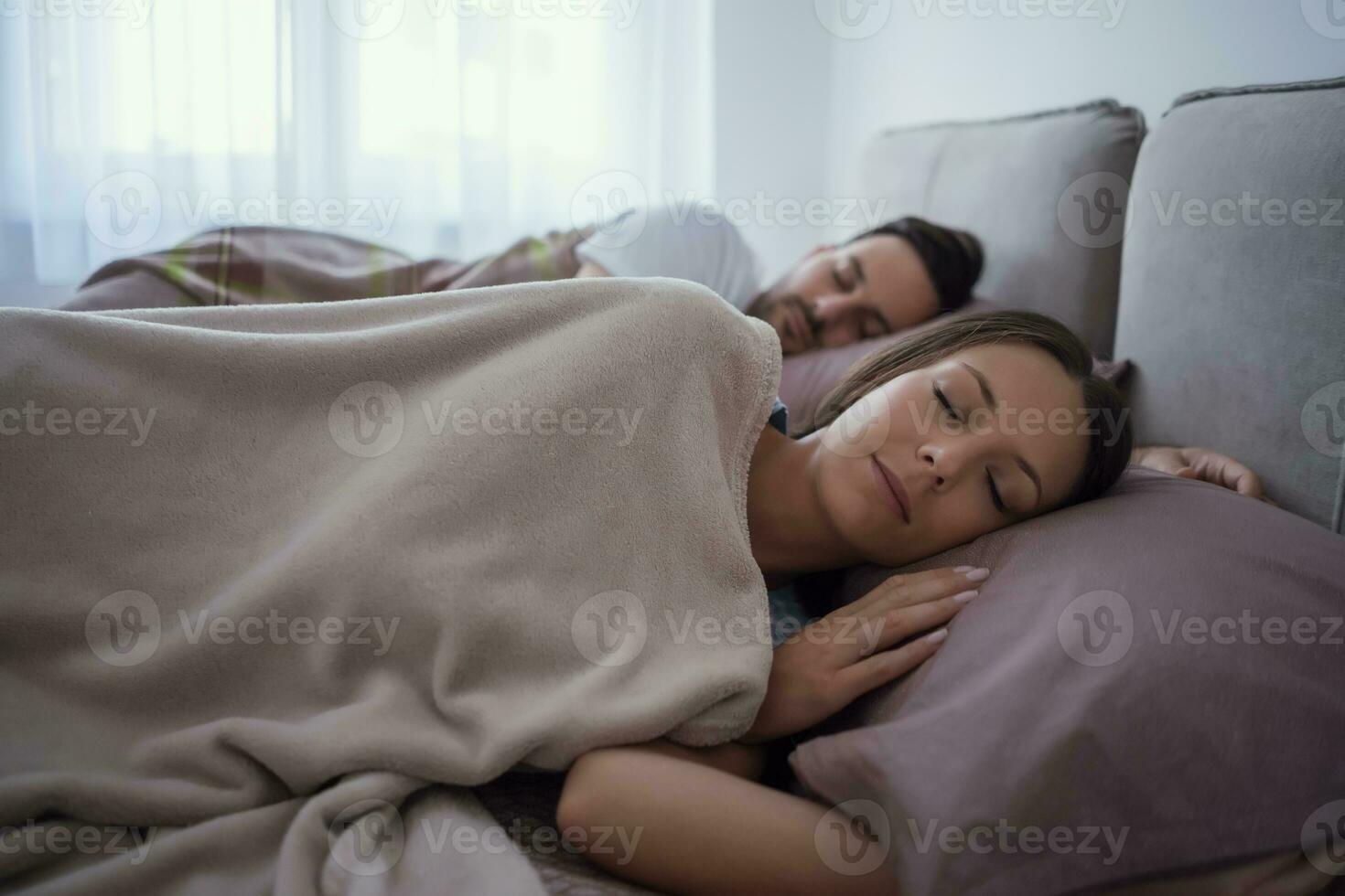 A young couple lying in bed photo