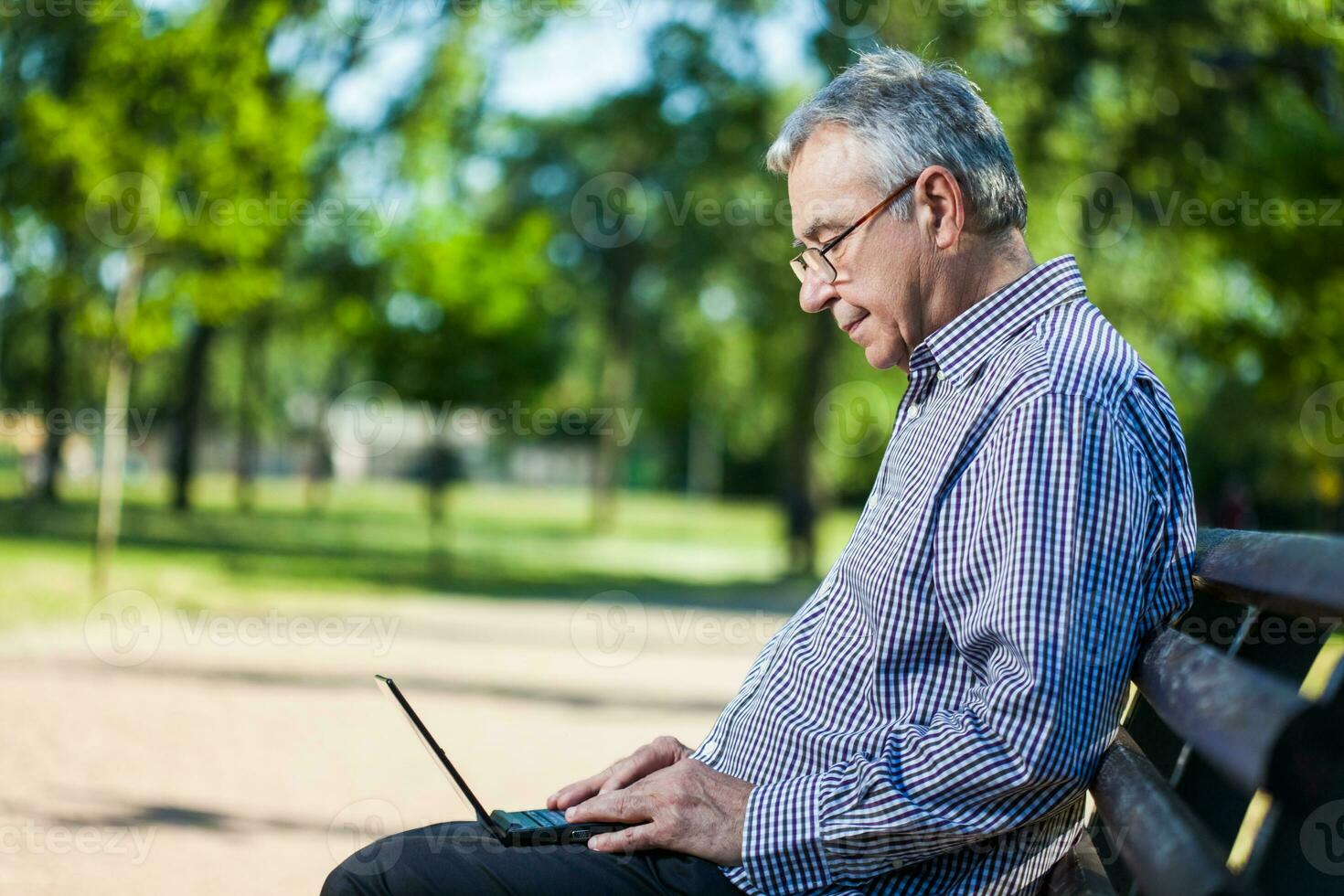 Portrait of a senior man on the park photo