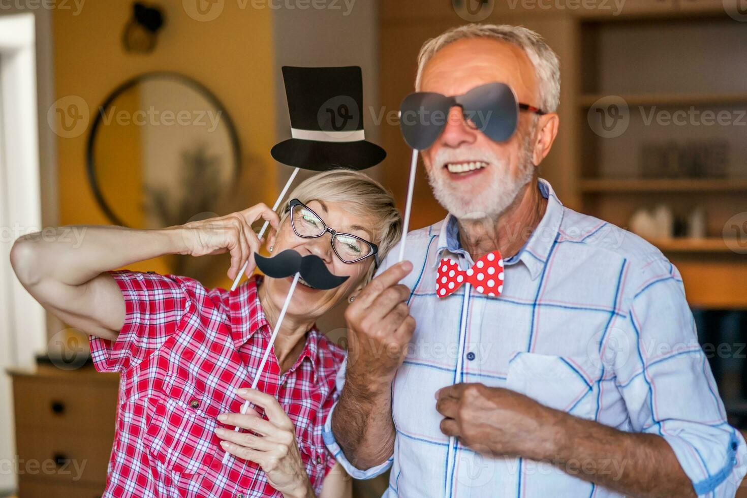 Happy mature couple is having fun at home. photo