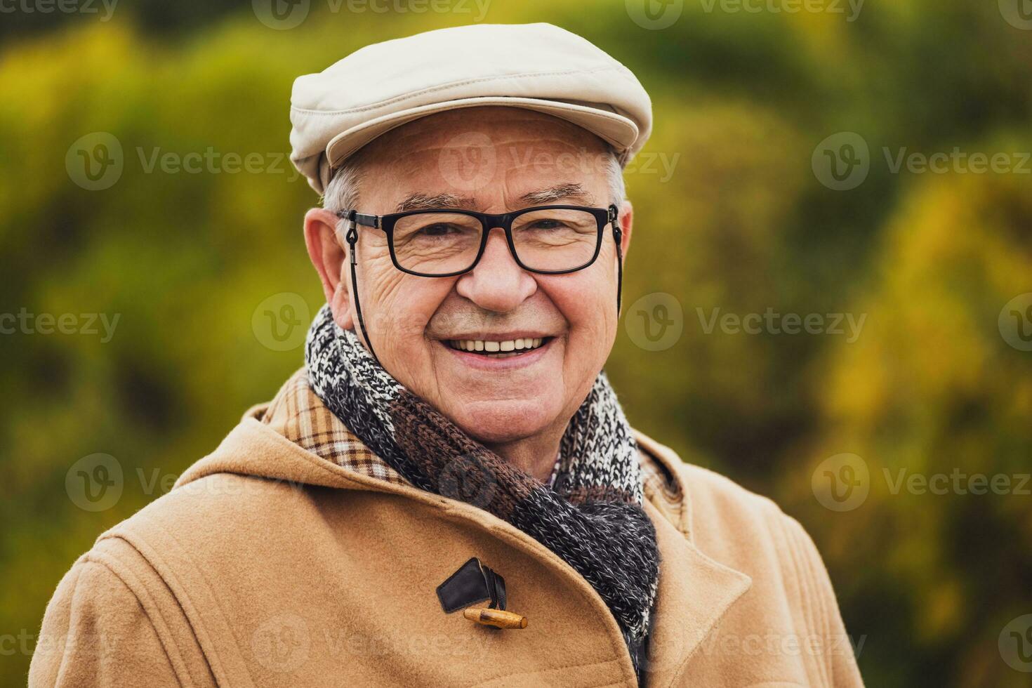 Outdoor portrait of a happy senior man in winter coat photo