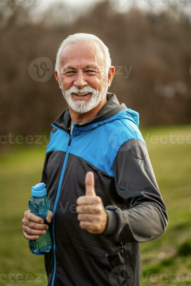 A senior man doing physical exercises photo