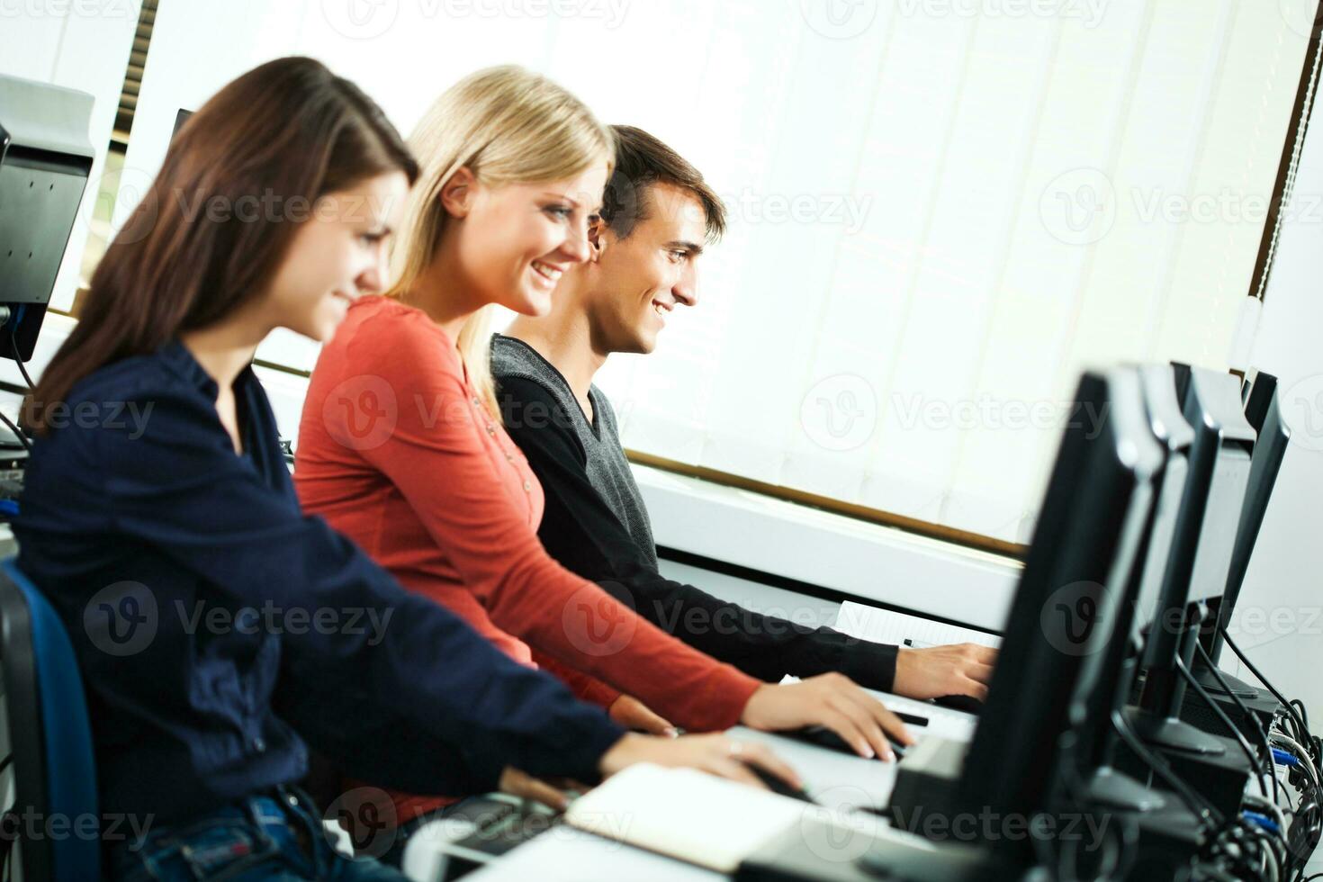 Students learning in a computer lab photo