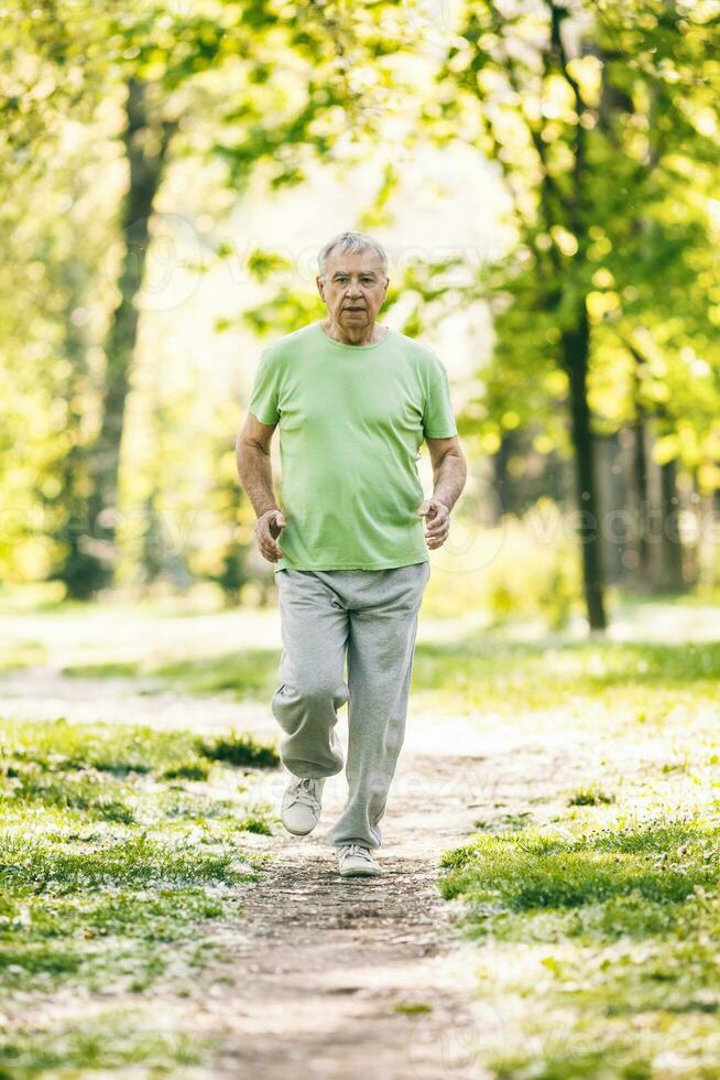 A senior man doing physical exercises photo