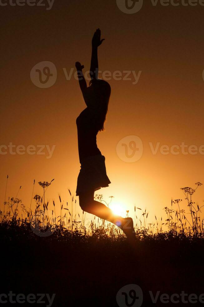 Silhouette of a woman at sunset photo