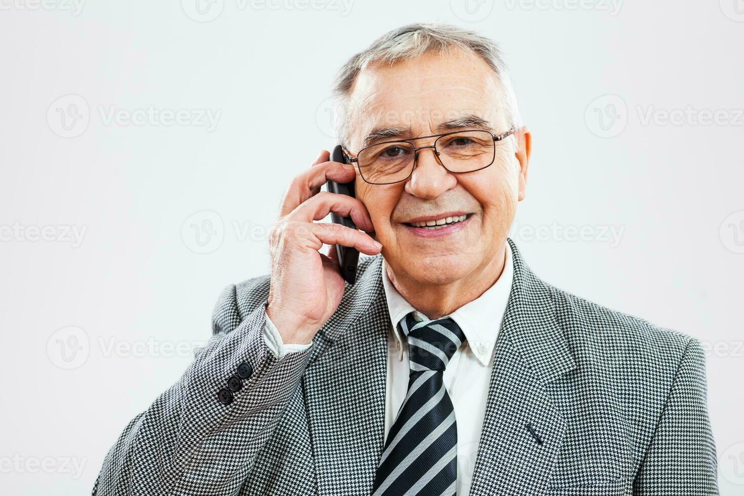 Portrait of a senior businessman on the phone photo