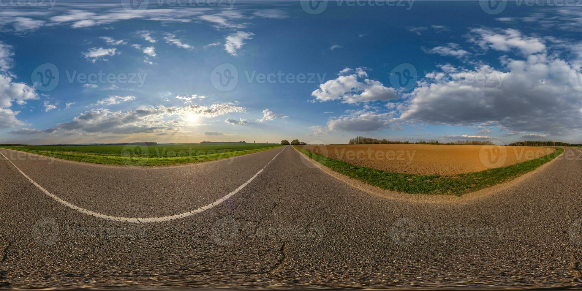 spherical 360 hdri panorama on old asphalt road with cracks with clouds and sun on evening blue sky in equirectangular seamless projection, as sky replacement in drone panoramas, game development photo