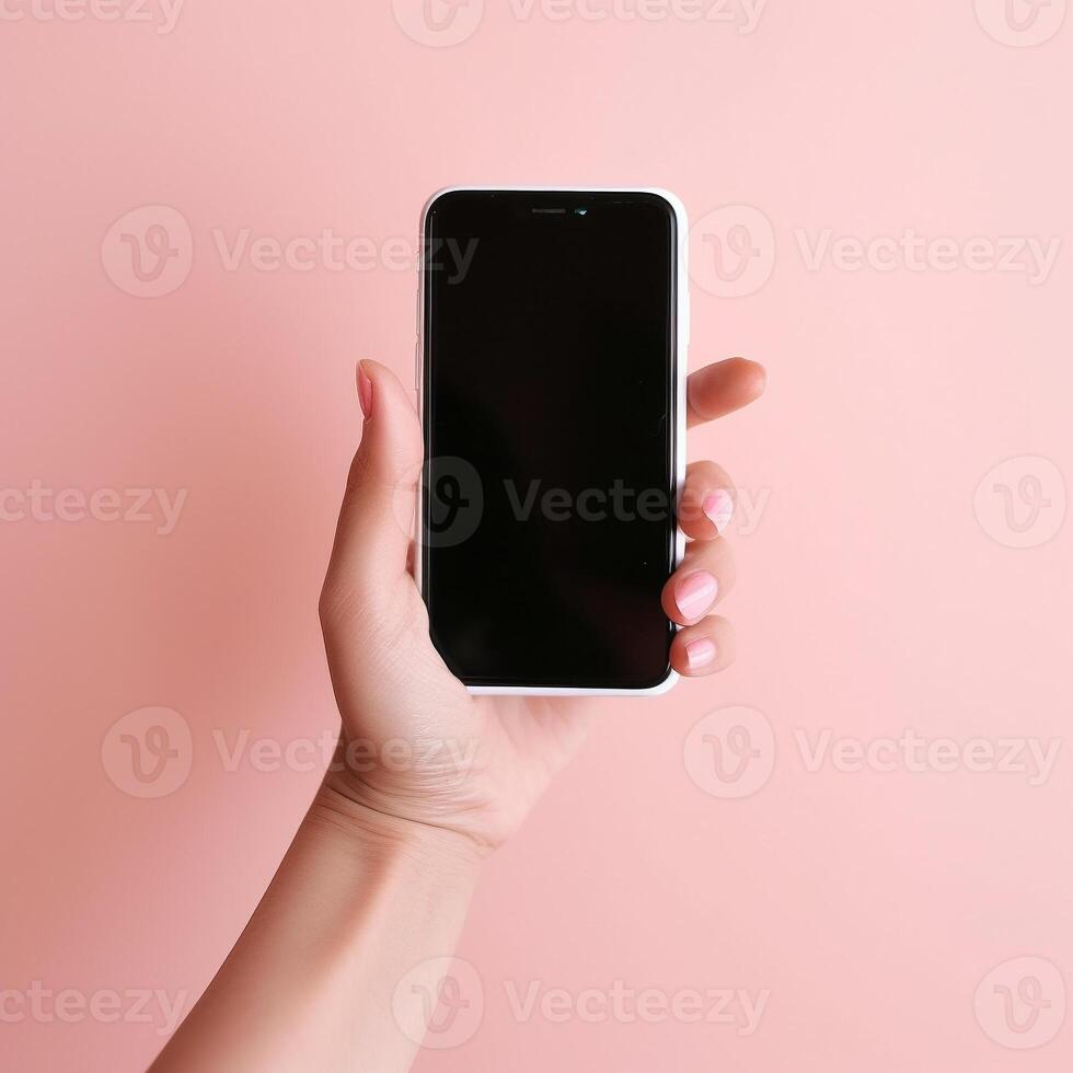 Mobile phone with empty white screen in hand on pink background photo