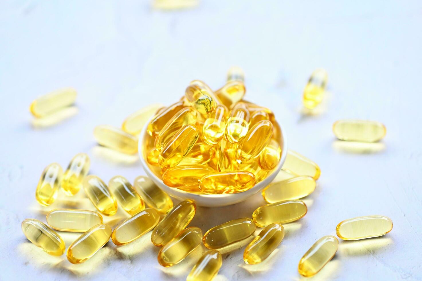 Fish oil capsules with omega 3 and vitamin D Cod liver oil omega 3 gel capsules, healthy diet concept photo