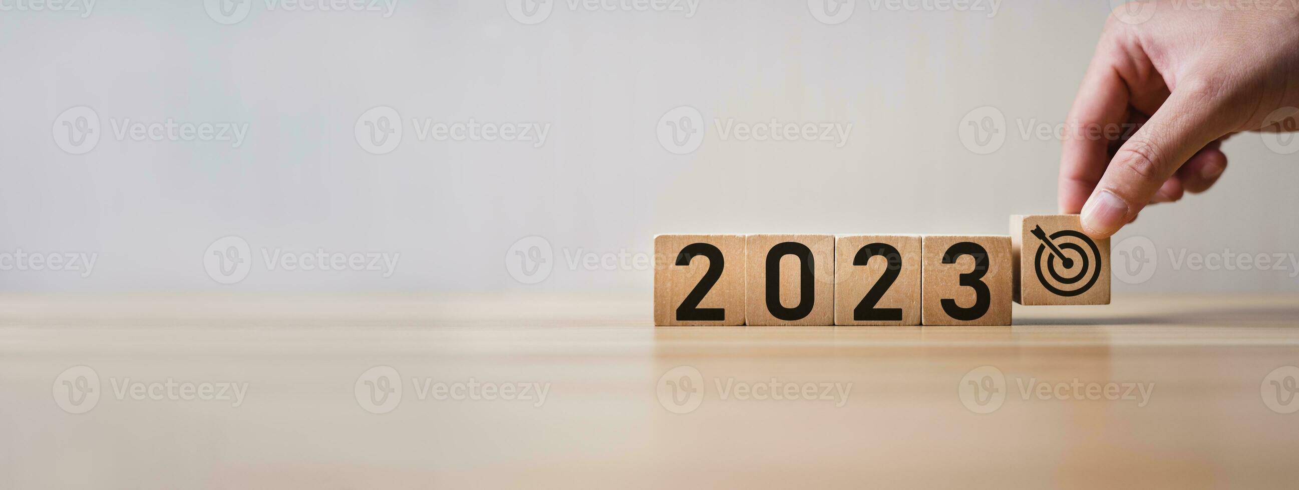Start new year 2023 with goal plan, goal concept, action plan, strategy, new year business vision. hand holding goal and cubes with text 2023. Development to success and motivation. photo