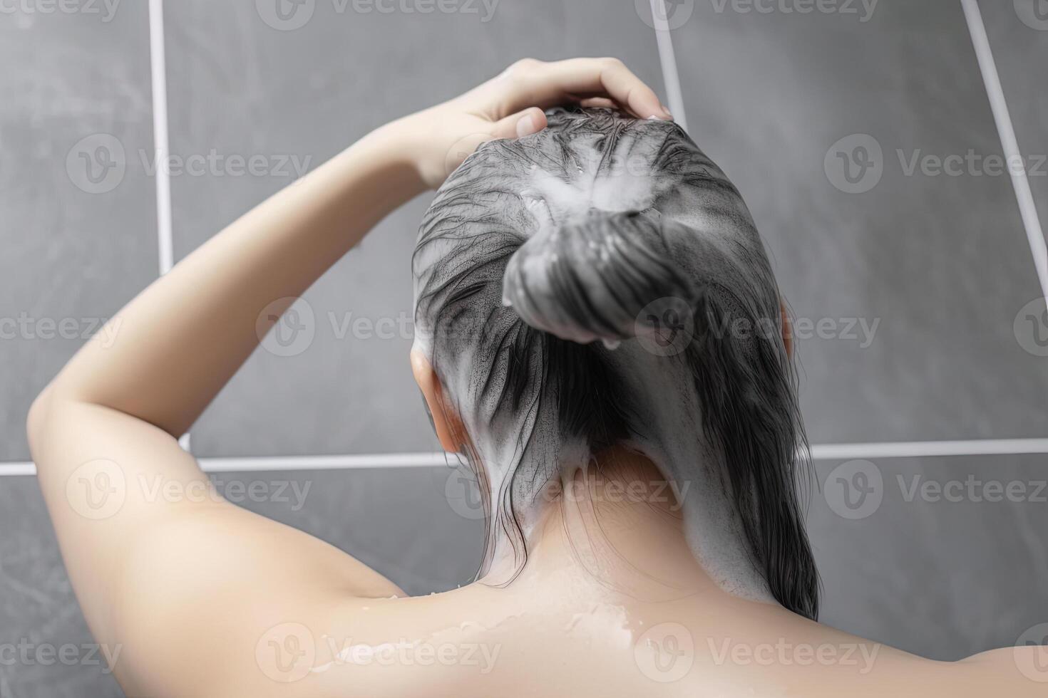 Woman washing hair with shampoo and shower in the bathroom. photo