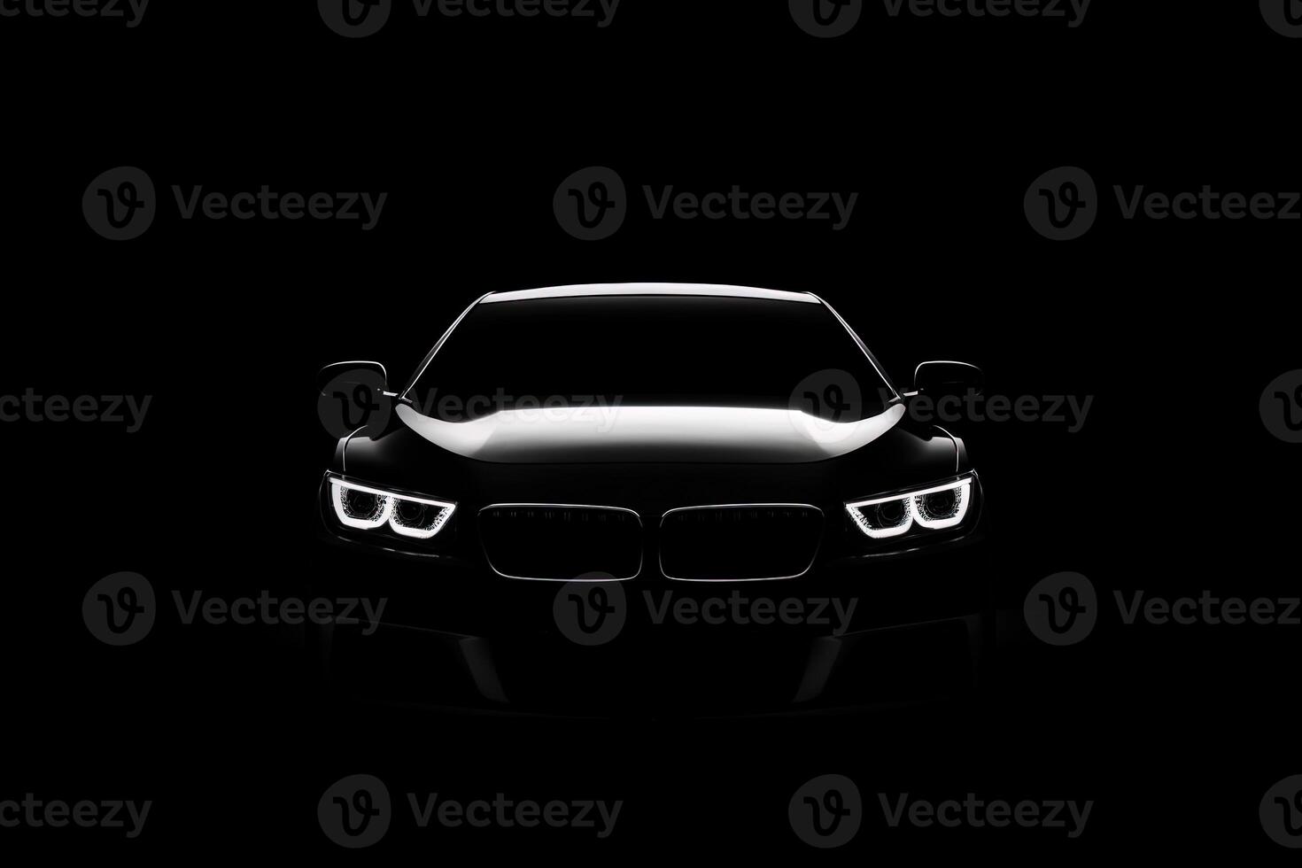 Front view dark silhouette of a modern luxury black car isolated on black background. photo