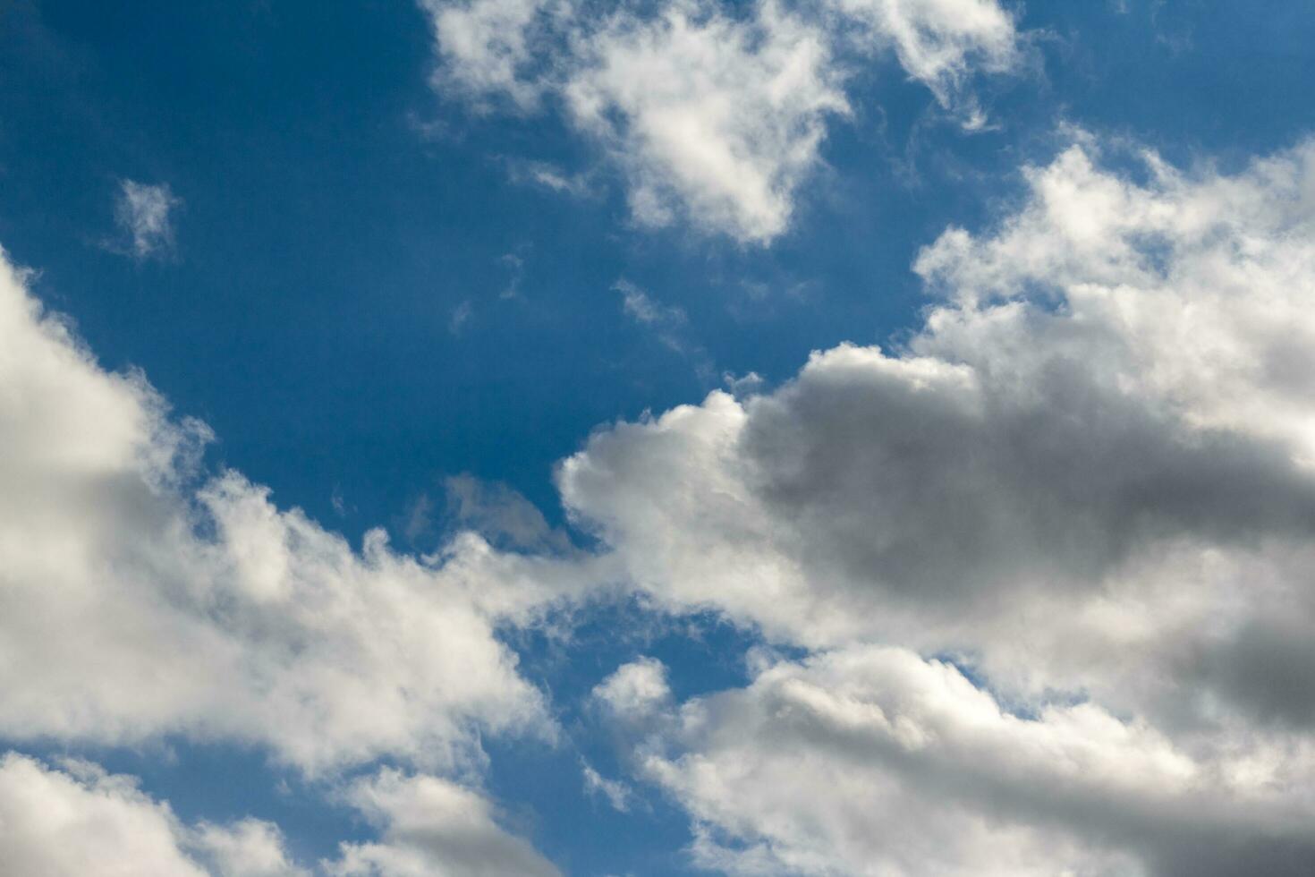 Air clouds on a dark sky. Light blue background in the air. Abstract style with place for text for design photo