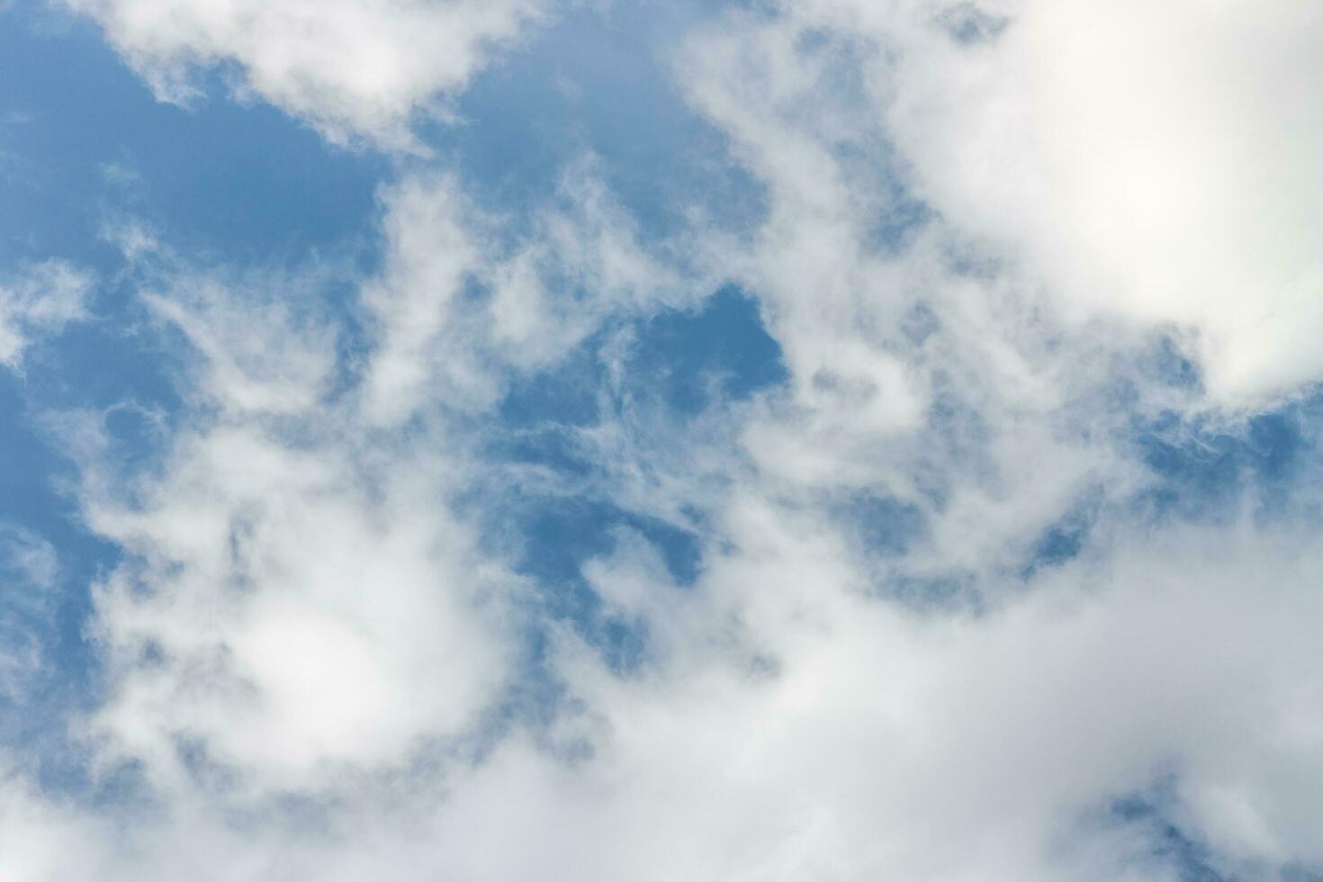 Air clouds on the blue sky. Light blue background in the air. Abstract style with place for text for design photo