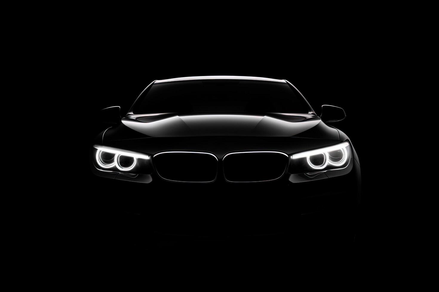 Front view dark silhouette of a modern luxury black car isolated on black background. photo