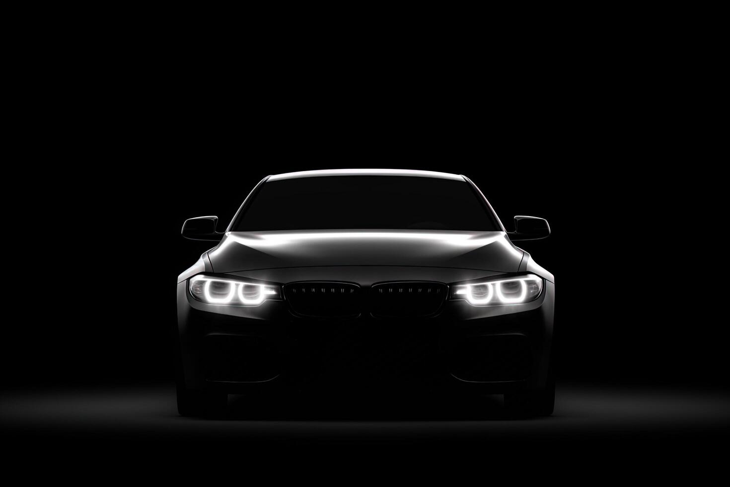 Front view dark silhouette of a modern luxury black car isolated on black background. photo