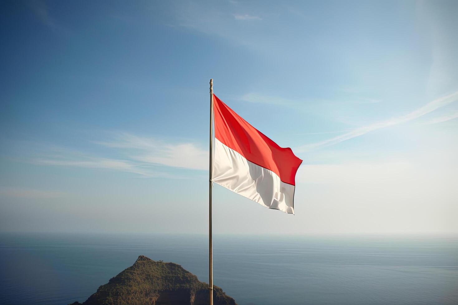 Indonesia national flag waving in the blue sky on the ocean background. Red and white flag with clouds. photo