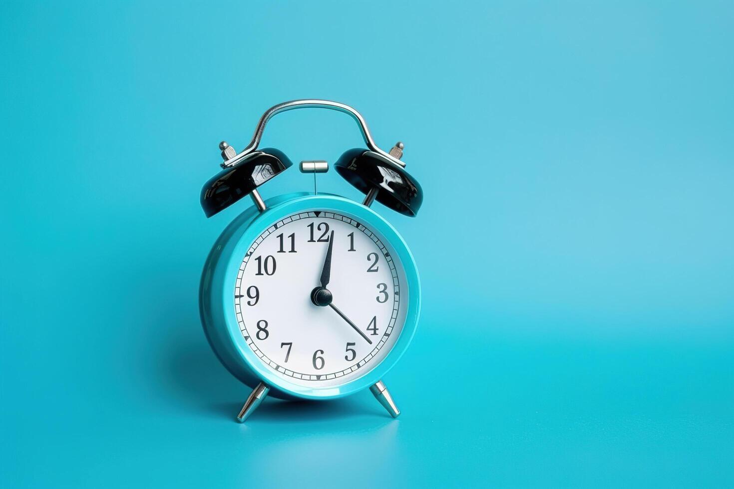 blue alarm clock on a blue background. photo