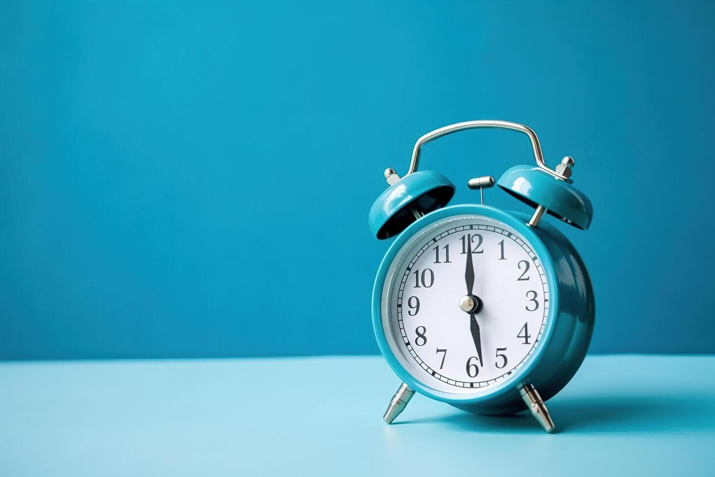 blue alarm clock on a blue background. photo