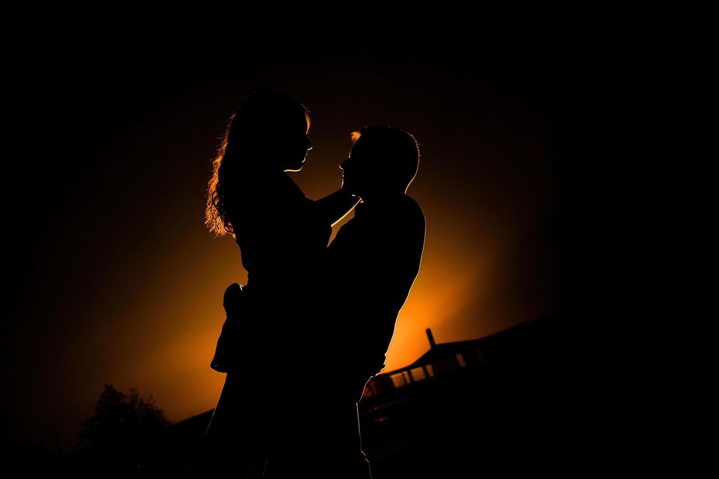 Silhouette of a romantic couple dancing and enjoying in the dark. photo