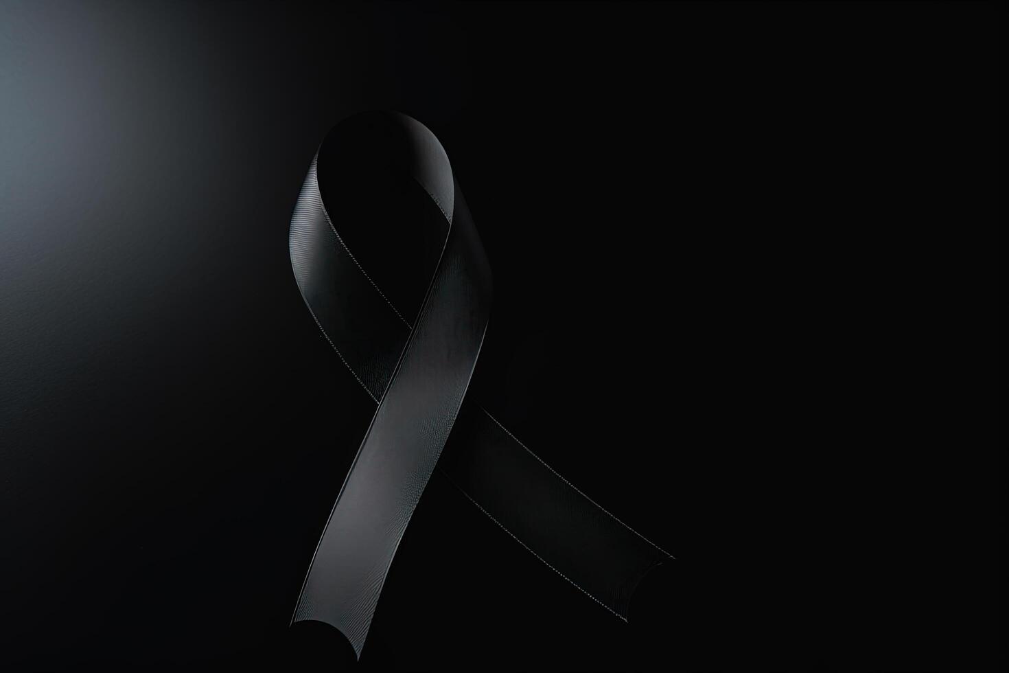 Black mourning ribbon with a dark background. photo