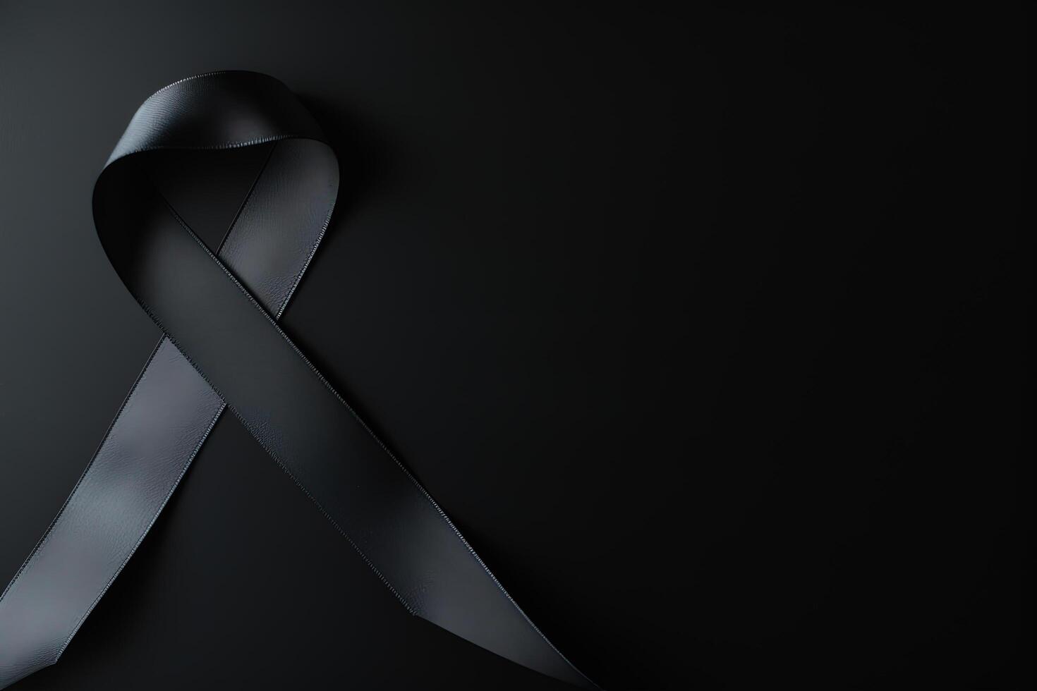 Black mourning ribbon with a dark background. photo