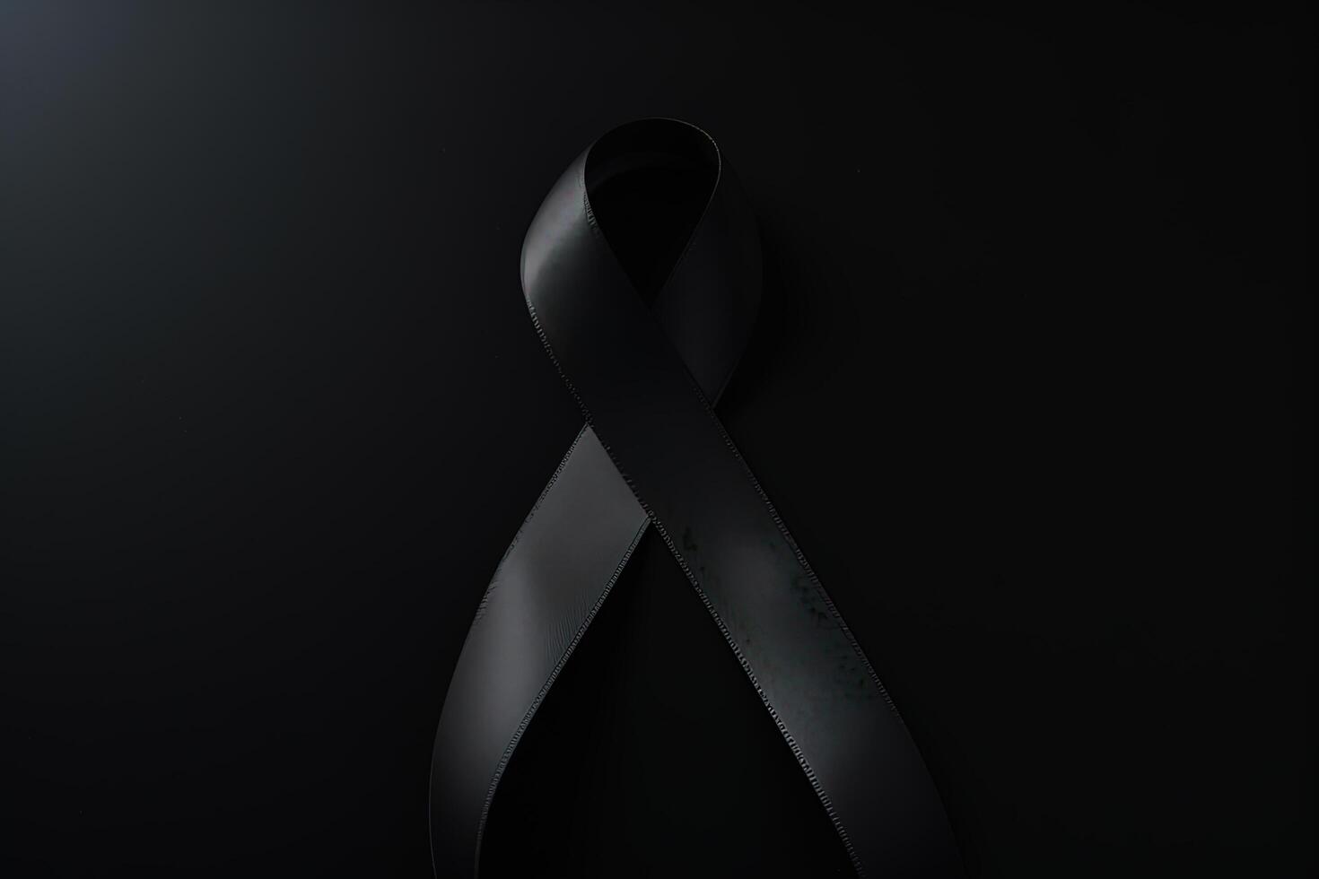 Black mourning ribbon with a dark background. photo