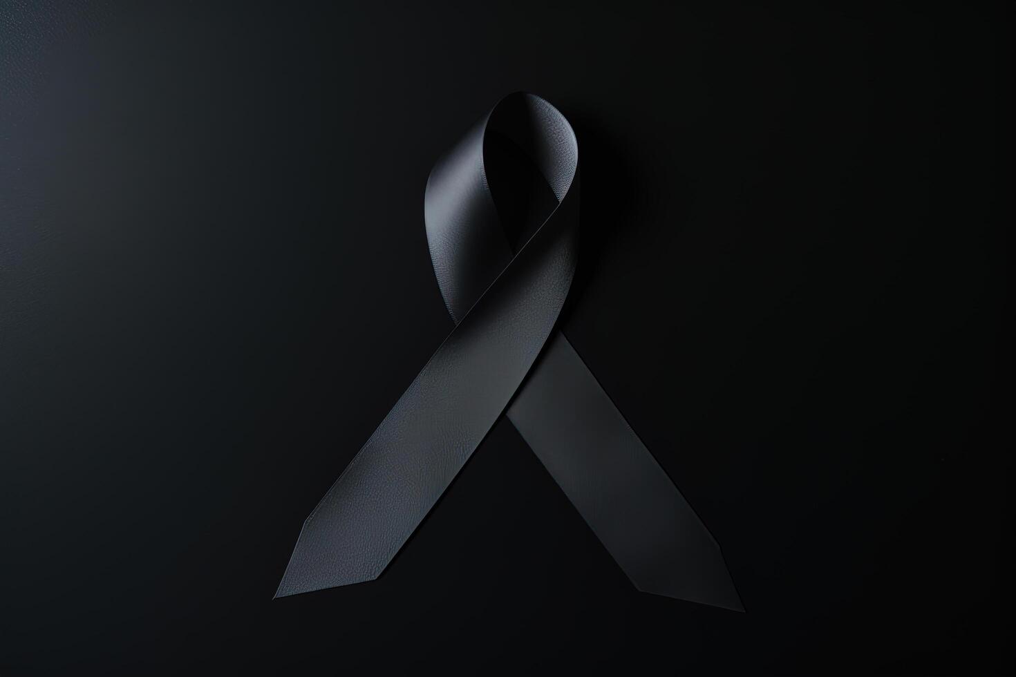 Black mourning ribbon with a dark background. photo