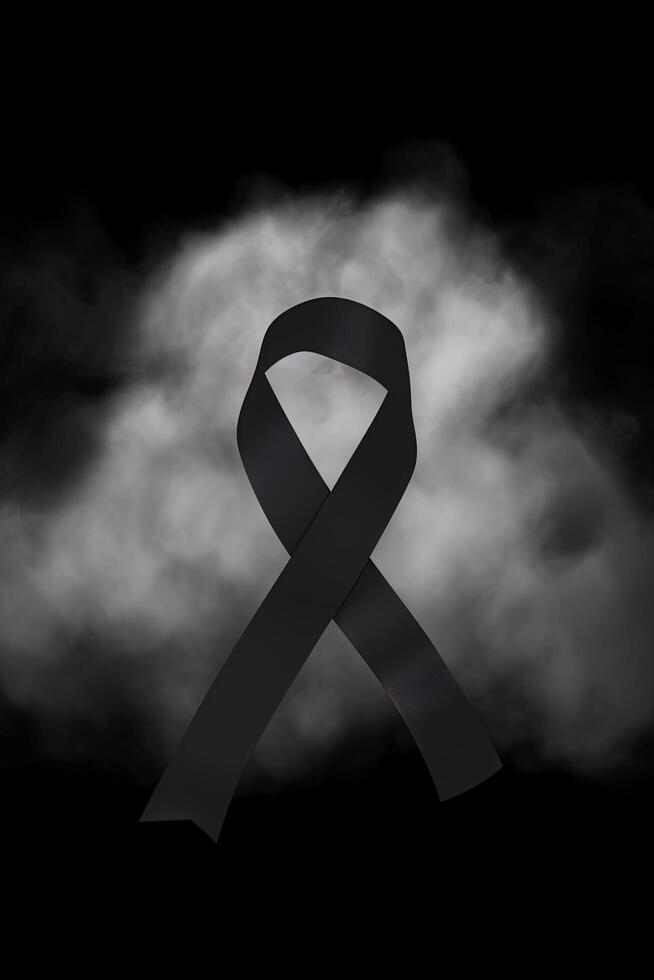 Black mourning ribbon with a dark smoke background. photo