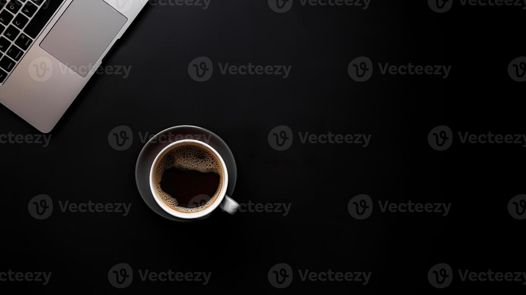 Laptop and coffee cup on black background. Top view with copy space. photo