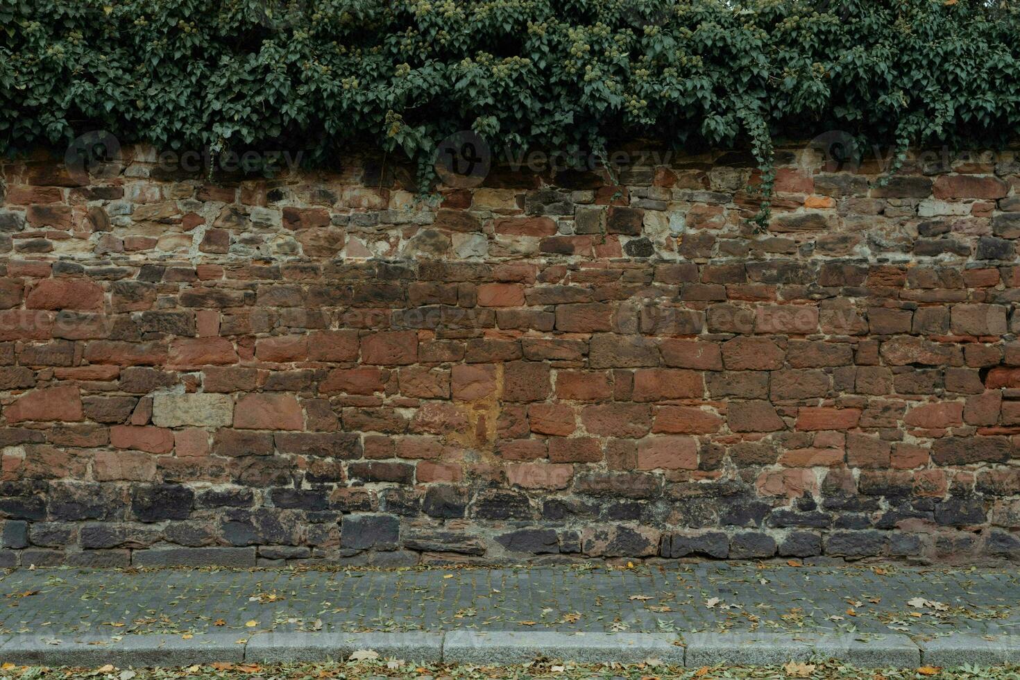 Stone wall and cobblestone sidewalk photo