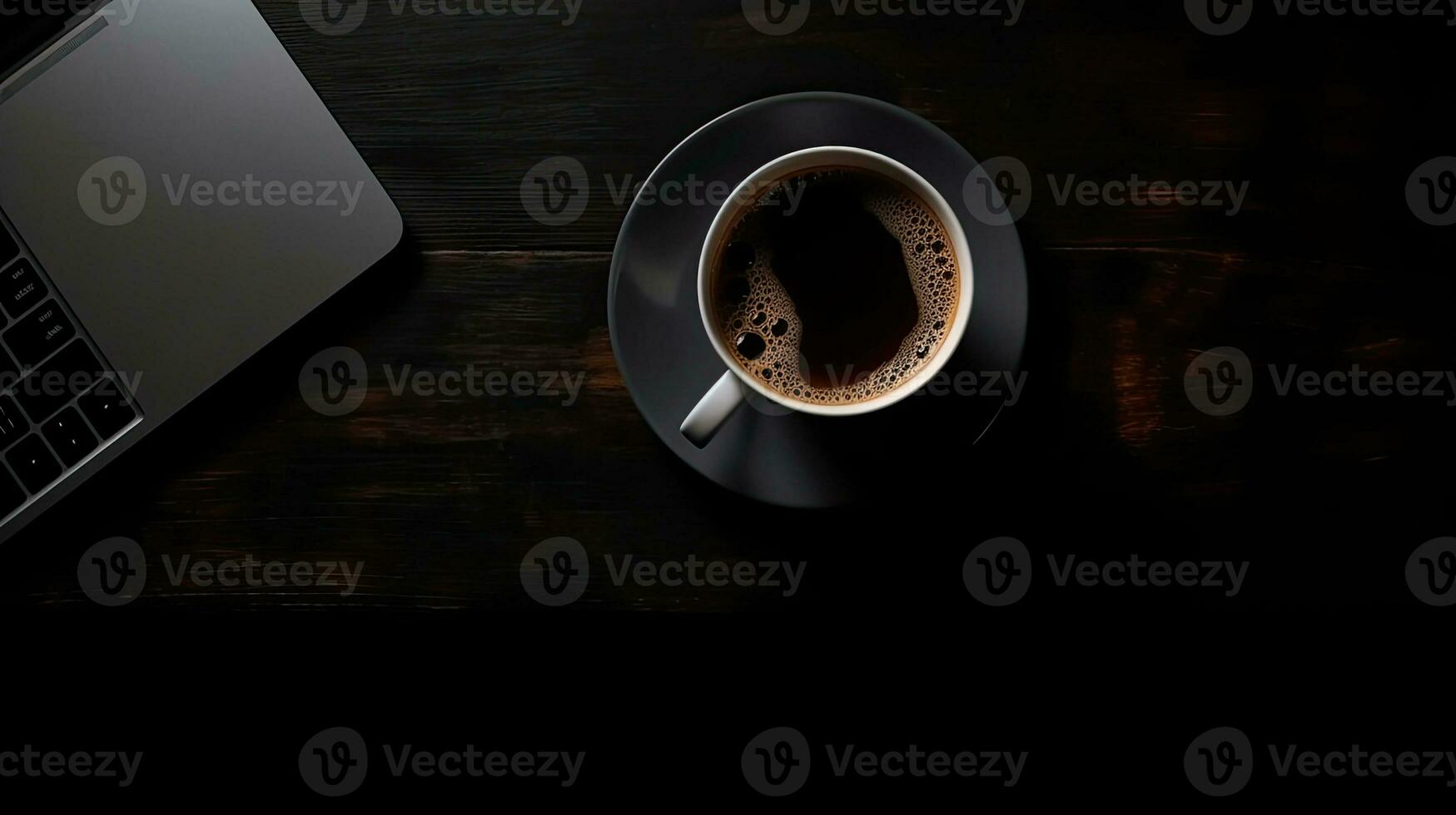 Laptop and coffee cup on black background. Top view with copy space photo