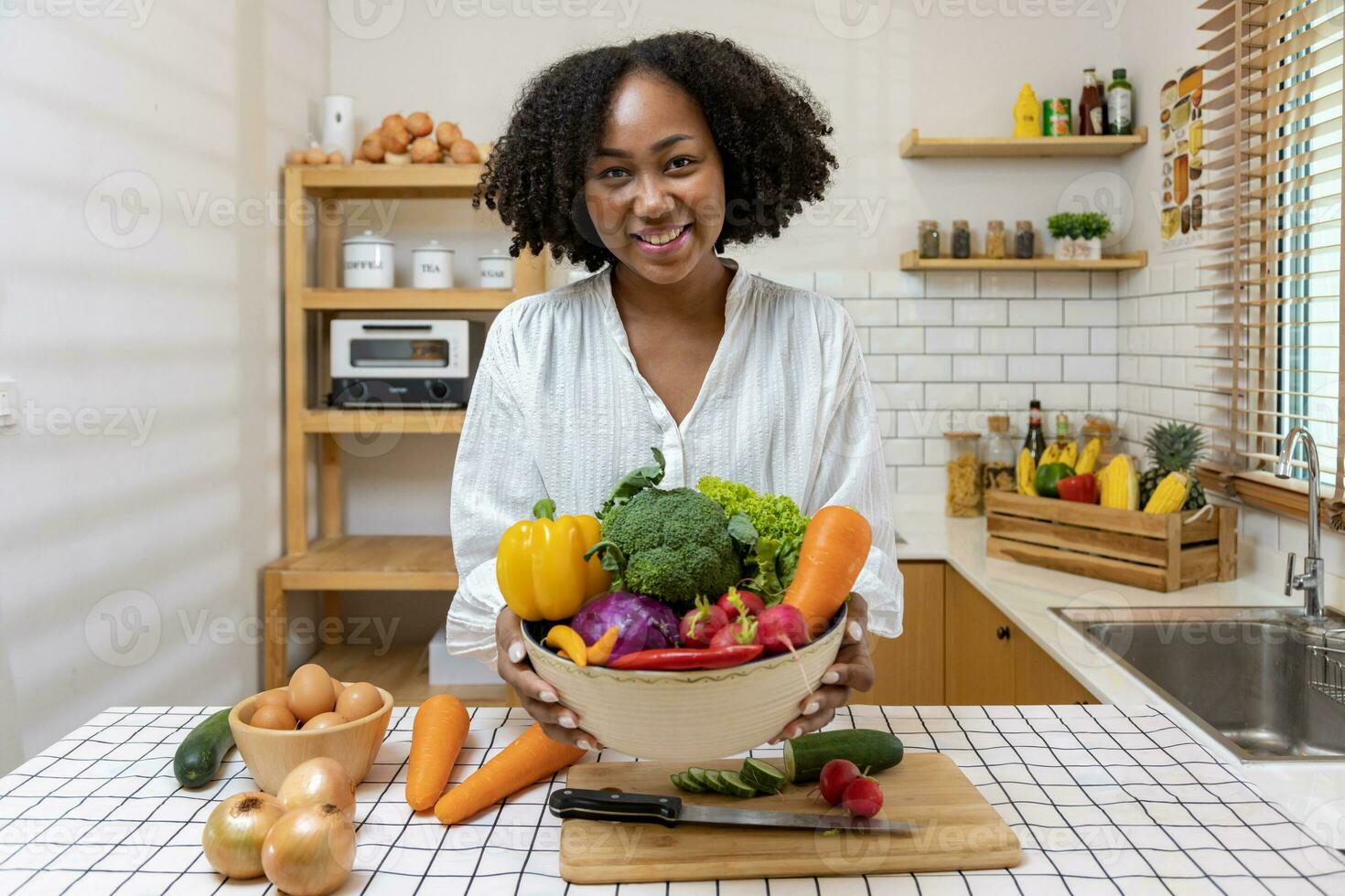 African American housewife is showing variety of organic vegetables to prepare simple and easy cajun southern style salad meal for vegan and vegetarian soul food concept photo