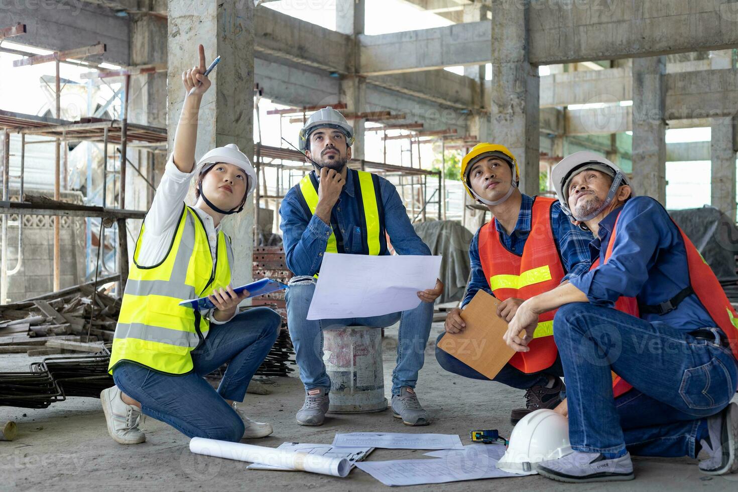 Team of engineer, architect, contractor and foreman meeting at the construction building site with floor plan for real estate development project industry and housing inspection timeline usage photo