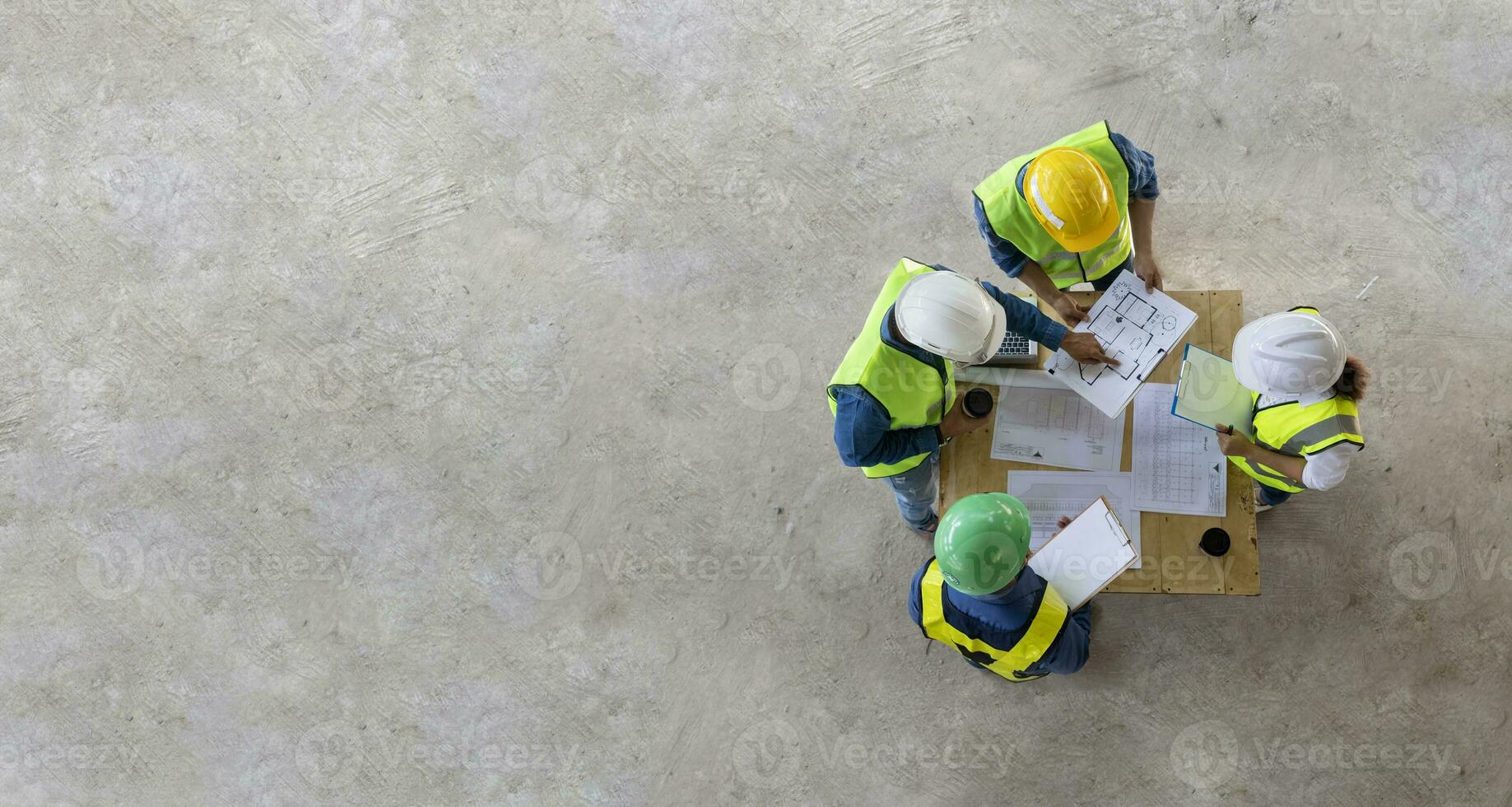 Top view of engineer, architect, contractor and foreman meeting at the construction building site with floor plan for real estate development project industry and housing timeline usage photo