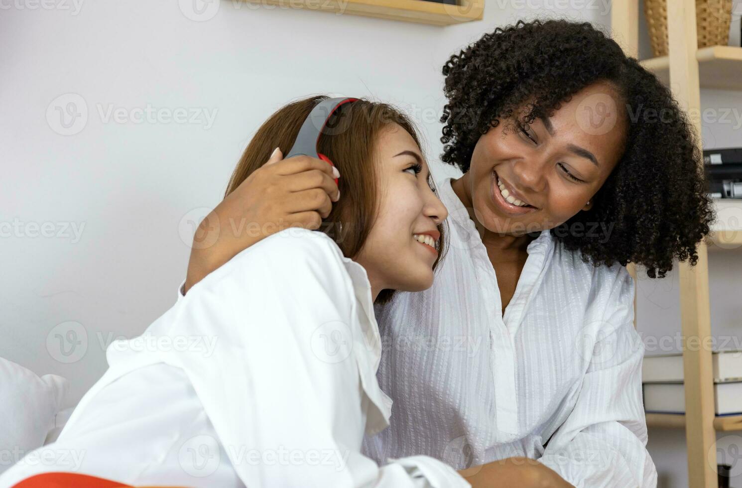 Couple woman of same sex marriage from difference races having lovely time together for pride month while lying down on bed to promote equality and differences of homosexual and discrimination concept photo